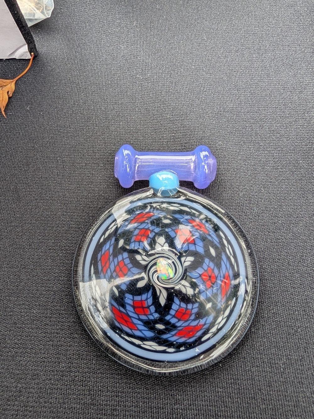 handcrafted glass pendant featuring a detailed multi-color fillacello pattern